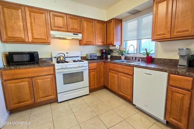 kitchen with light tile patterned floors, sink, and white appliances