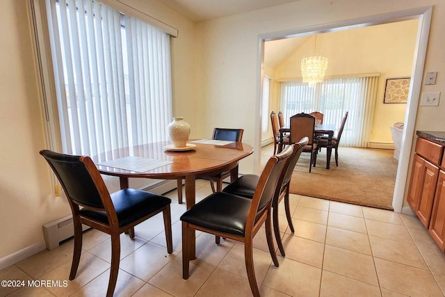 dining room with a notable chandelier, light tile patterned flooring, and a baseboard radiator