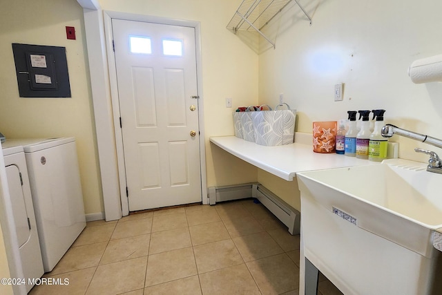 clothes washing area featuring light tile patterned floors, electric panel, sink, and washing machine and dryer