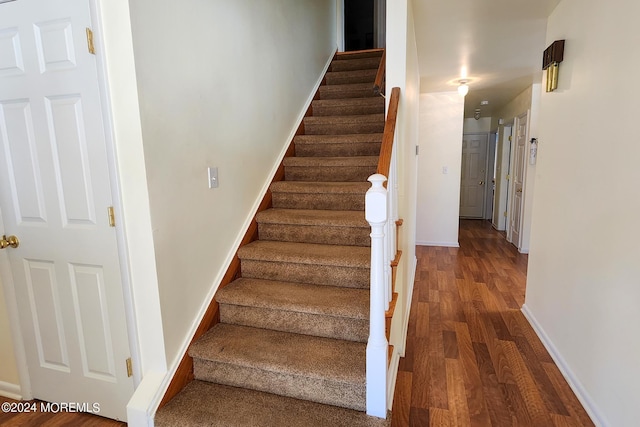 stairs featuring wood-type flooring