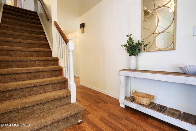 stairs featuring hardwood / wood-style floors