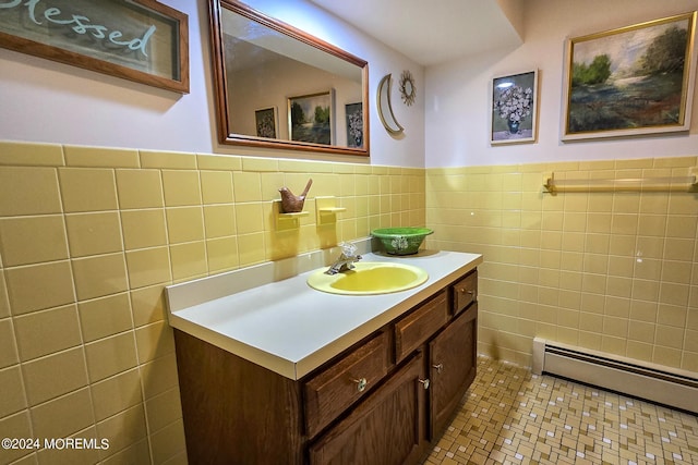 bathroom featuring tile patterned flooring, vanity, tile walls, and a baseboard heating unit