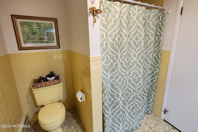 bathroom featuring toilet, tile walls, and tile patterned floors