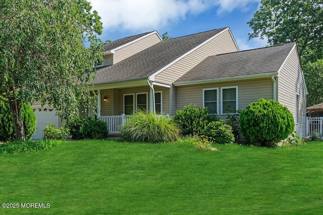 view of front of home with a front lawn, a porch, and a garage