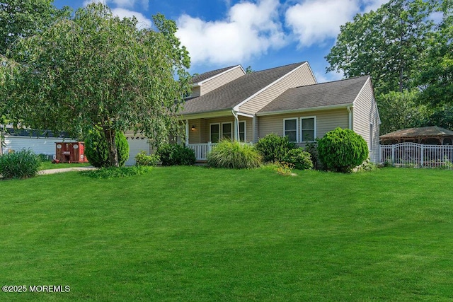 view of front of home featuring a front lawn, a garage, and a porch