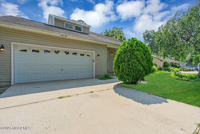 garage featuring a lawn