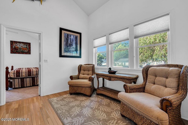 sitting room featuring vaulted ceiling and light hardwood / wood-style flooring