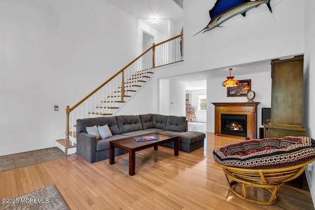 living room with a high ceiling and hardwood / wood-style flooring