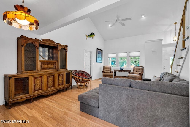 living room featuring ceiling fan, wood-type flooring, high vaulted ceiling, and beamed ceiling