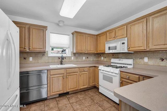 kitchen with light tile patterned flooring, decorative backsplash, sink, and white appliances