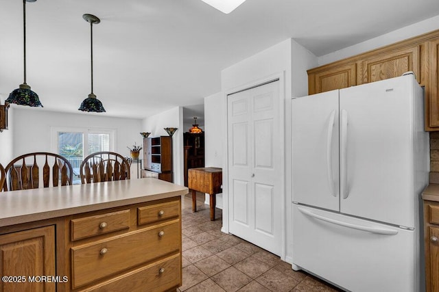 kitchen featuring white refrigerator and decorative light fixtures