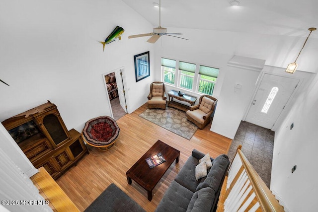 living room featuring high vaulted ceiling, wood-type flooring, and ceiling fan