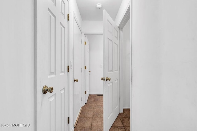 hall with tile patterned flooring