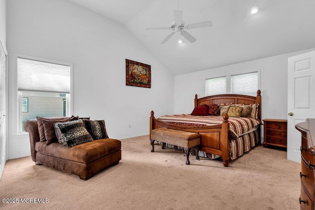 bedroom with ceiling fan, light colored carpet, and lofted ceiling