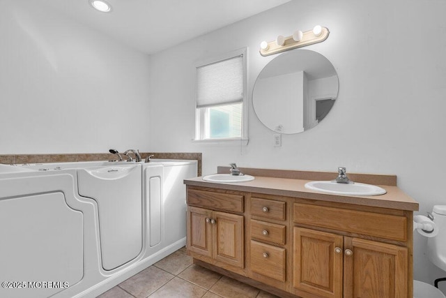 bathroom featuring toilet, vanity, and tile patterned flooring