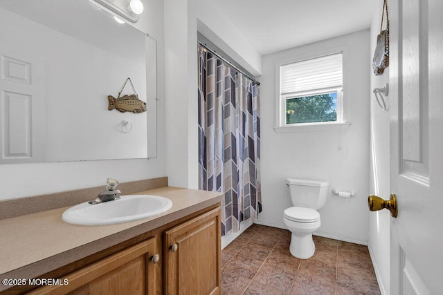 bathroom with toilet, vanity, and a shower with curtain