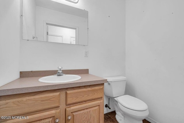 bathroom featuring toilet, tile patterned floors, and vanity