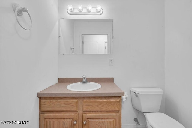 bathroom with toilet and vanity