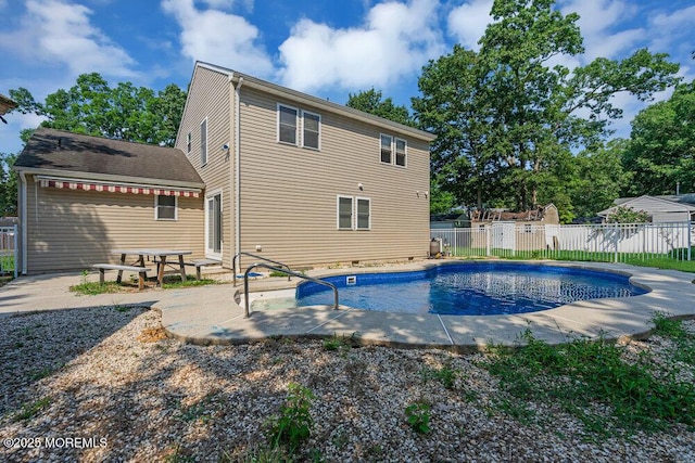 back of house with a fenced in pool and a patio