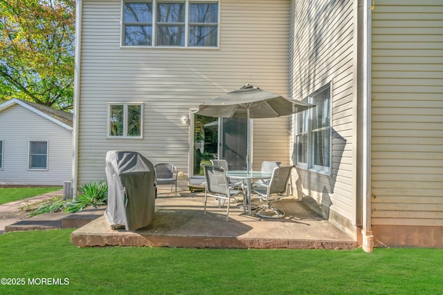 rear view of house featuring a patio area and a yard