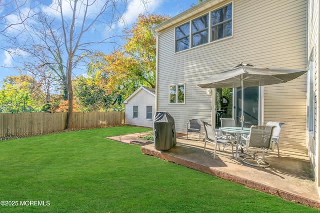 back of house featuring a patio area and a lawn