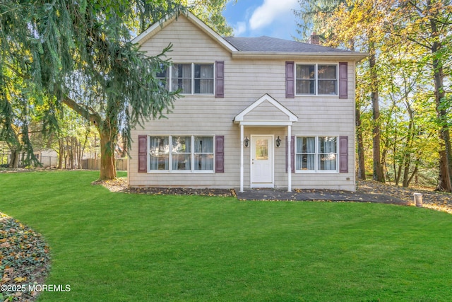 colonial-style house with a front lawn