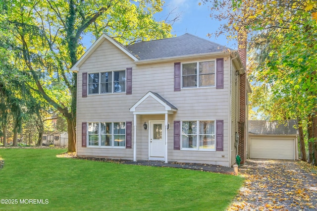 colonial home featuring a garage and a front yard