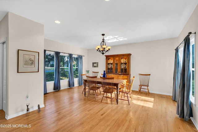 dining area with a chandelier and light hardwood / wood-style floors