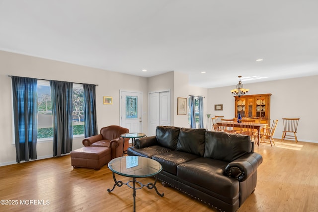 living room with a chandelier and light hardwood / wood-style floors