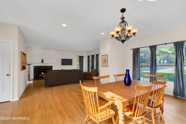 dining space featuring a chandelier and light hardwood / wood-style flooring