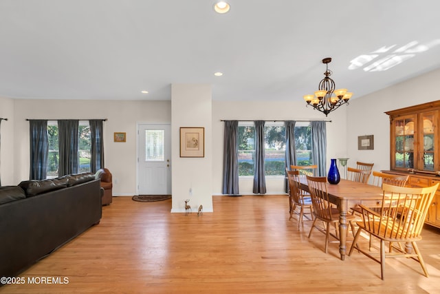 dining room featuring light wood-type flooring and a chandelier