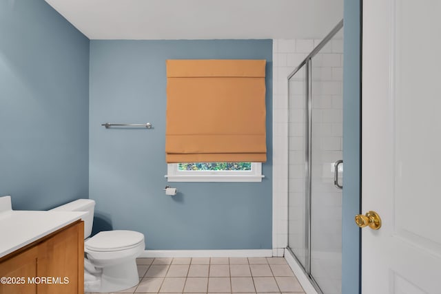 bathroom with toilet, vanity, tile patterned floors, and a shower with shower door