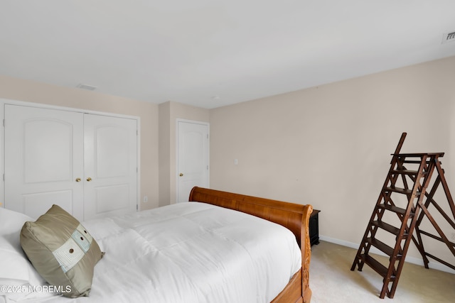 bedroom with a closet and light carpet