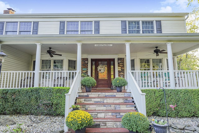 entrance to property featuring ceiling fan and a porch