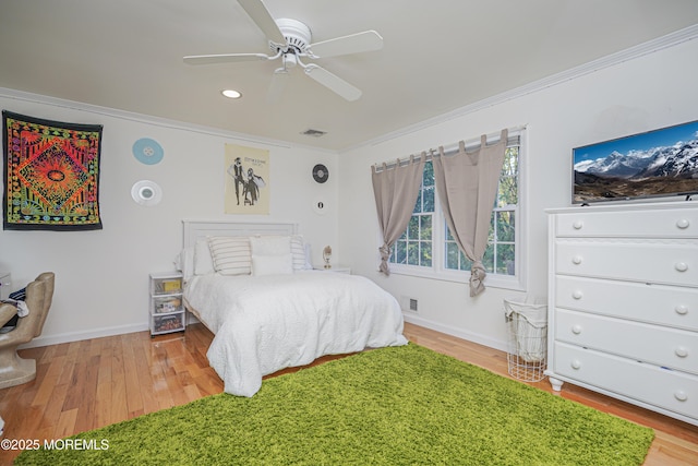 bedroom with ceiling fan, ornamental molding, and light hardwood / wood-style floors