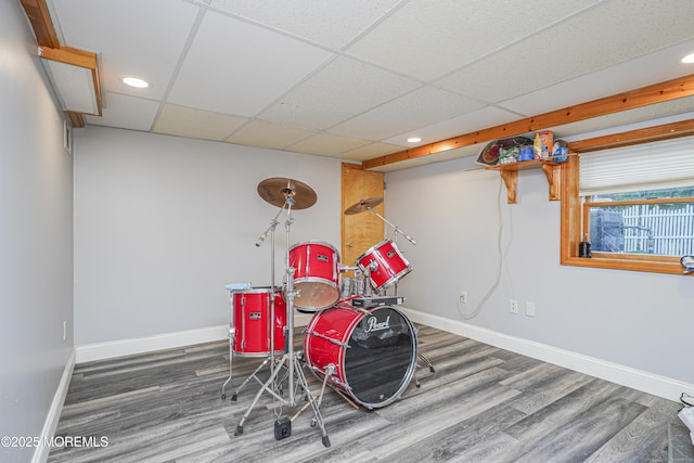 game room with a drop ceiling and wood-type flooring