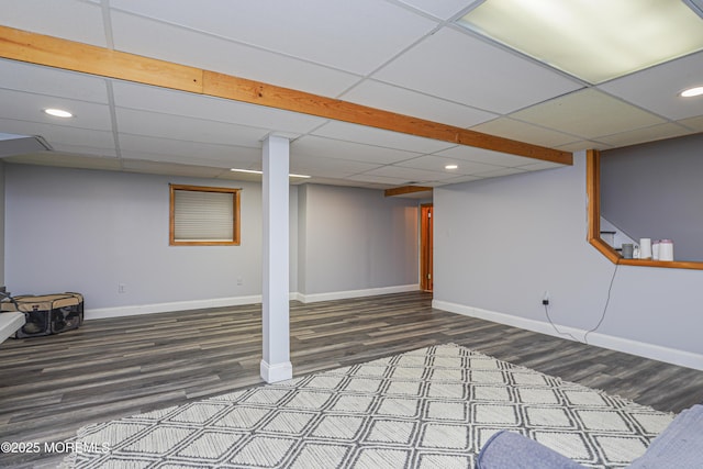 basement with a paneled ceiling and hardwood / wood-style flooring