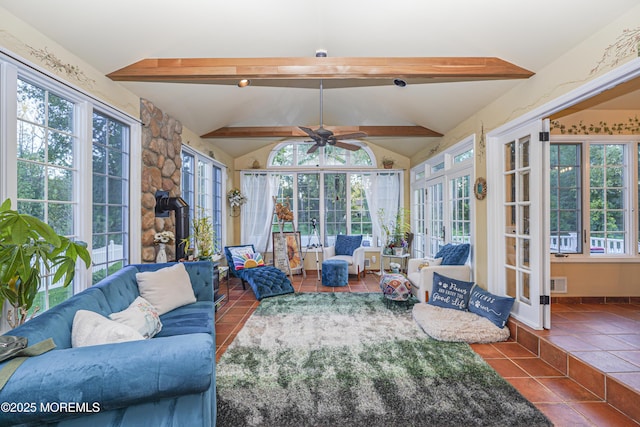 sunroom / solarium with ceiling fan, lofted ceiling with beams, and a wealth of natural light