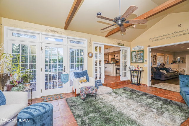 tiled living room with ceiling fan, lofted ceiling with beams, and french doors