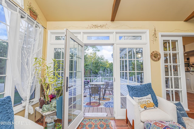 sunroom featuring beamed ceiling