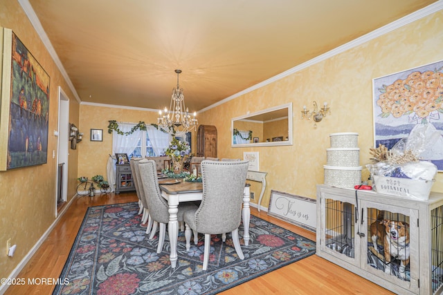 dining area featuring ornamental molding, a chandelier, and hardwood / wood-style floors