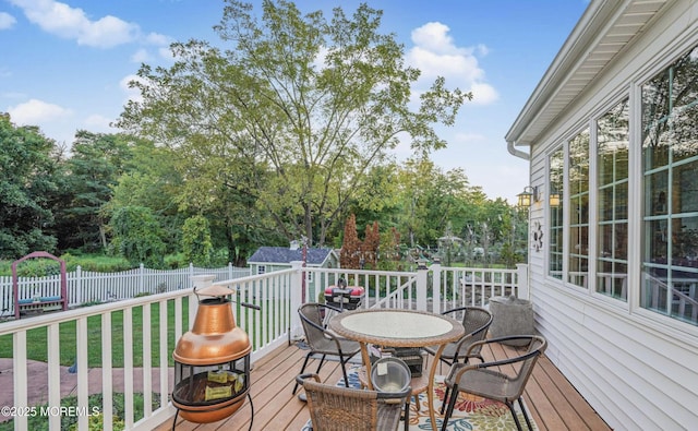 wooden terrace with a yard