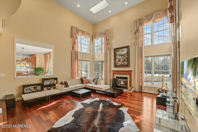 living room featuring a wealth of natural light, a high ceiling, and hardwood / wood-style flooring