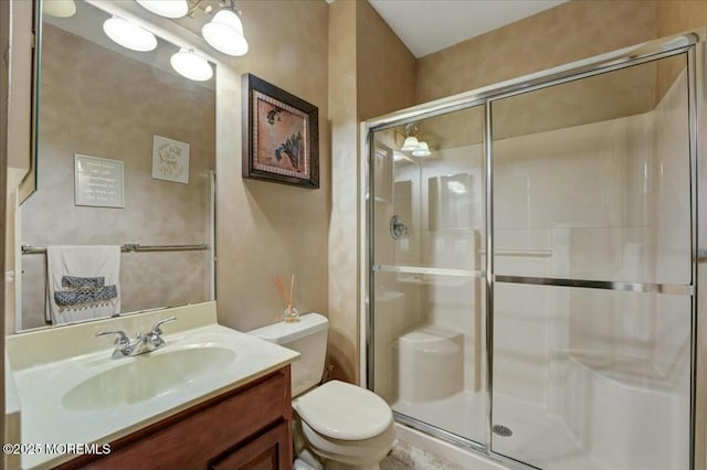 bathroom with toilet, a shower with door, and vanity