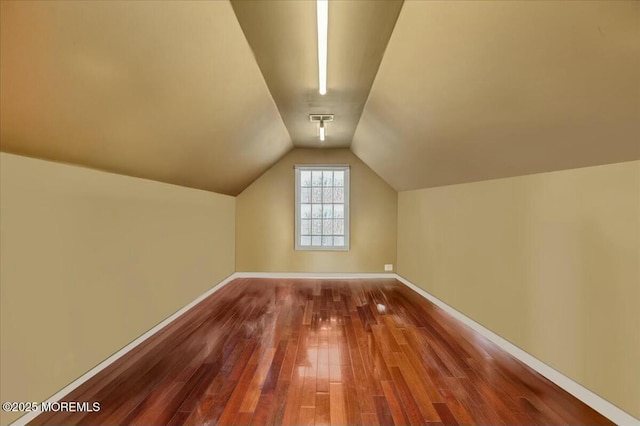 bonus room with lofted ceiling and wood-type flooring