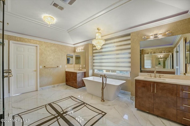 bathroom with lofted ceiling, vanity, a tub, ornamental molding, and a chandelier