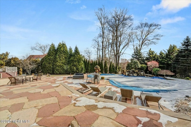 view of pool with a hot tub and a patio area