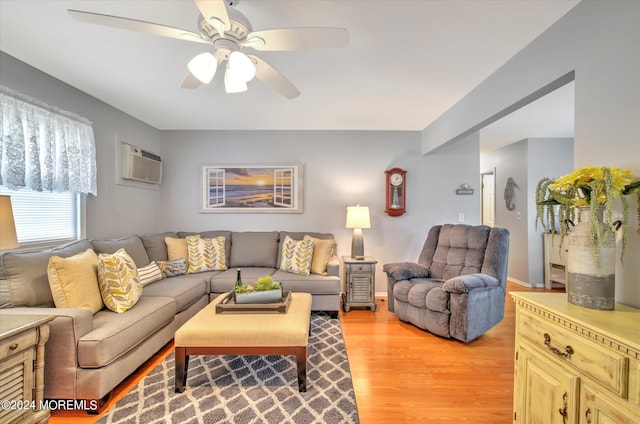 living room with ceiling fan, light hardwood / wood-style floors, and an AC wall unit