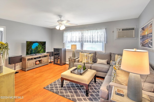 living room featuring a wall unit AC, ceiling fan, a baseboard heating unit, and wood-type flooring