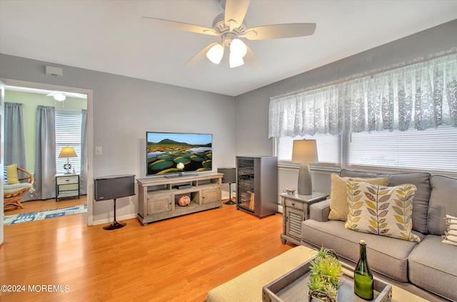 living room featuring ceiling fan and light wood-type flooring